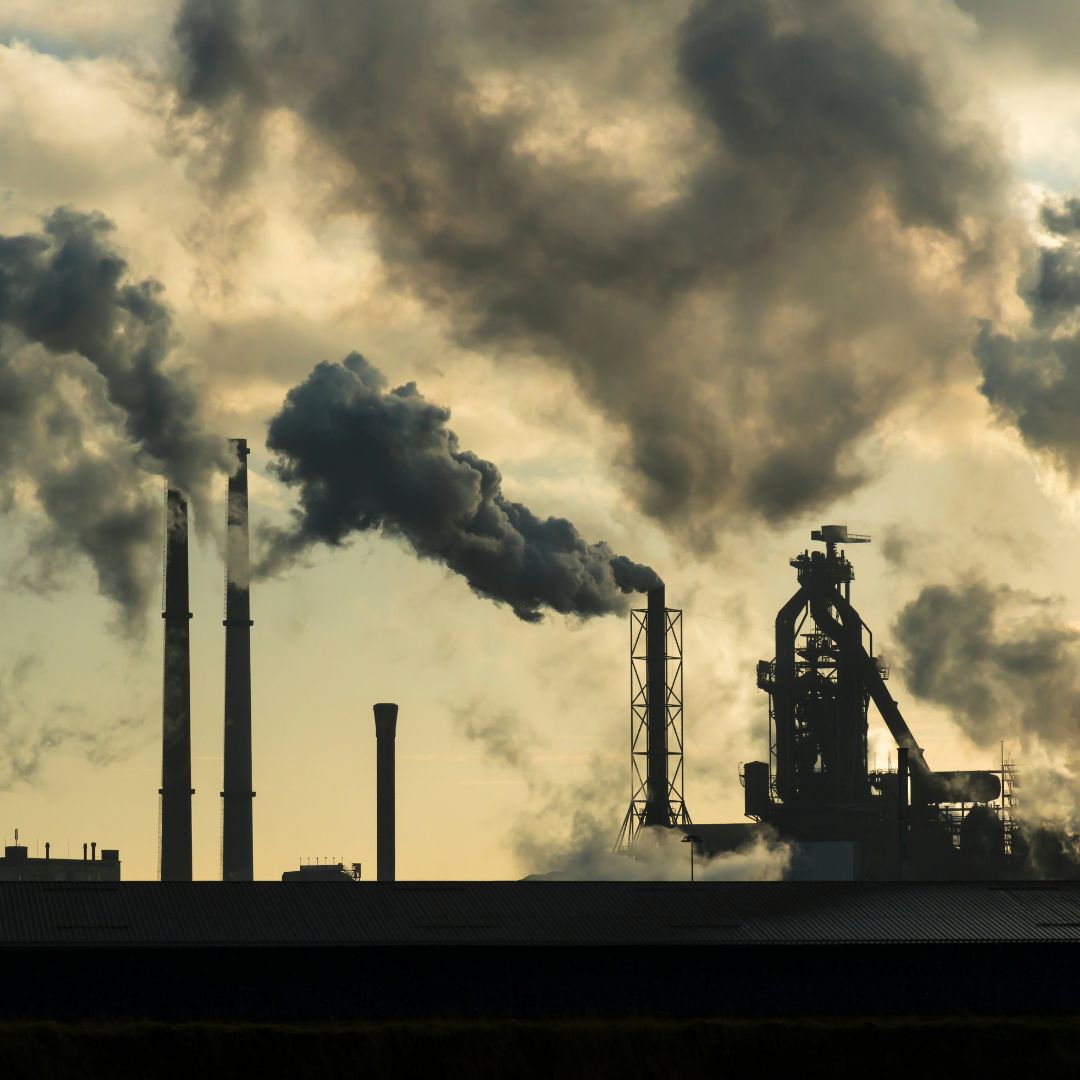 sepia toned photo of polluting smoke stacks meant to show what the repeal of federal regulation and standards like the endangerment finding will bring to Indiana communities where Hoosiers will experience public health effects like asthma and contaminated water