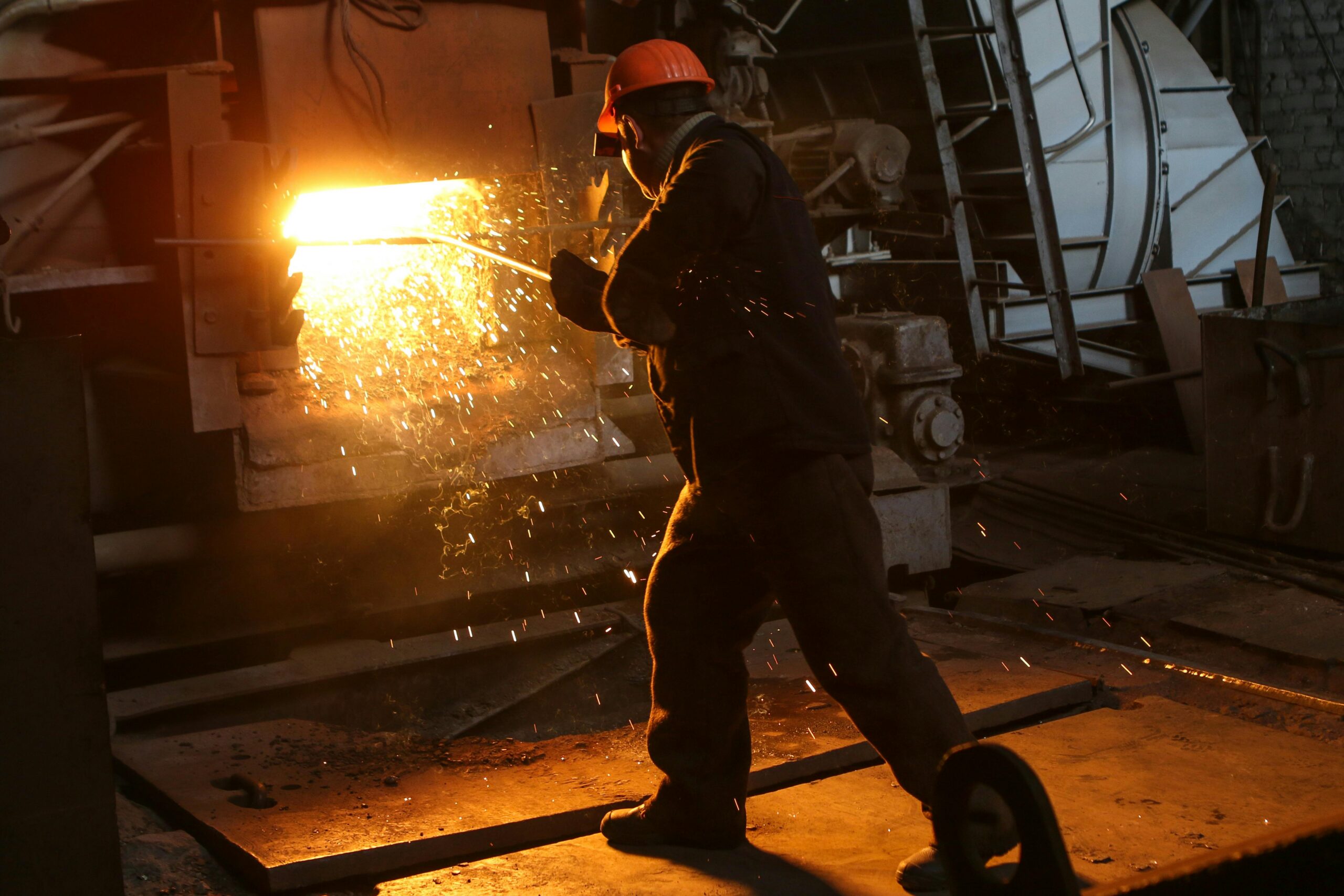 stock photo of person working in steel furnace